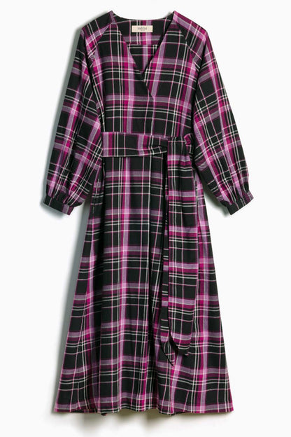 A long-sleeve plaid wrap dress with a tie waist belt, featuring a pink and black tartan pattern with thin white lines, shown against a light gray background.