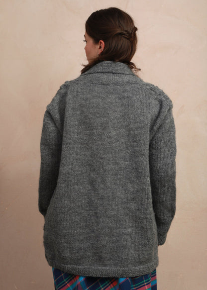 Back view of model wearing the natural charcoal grey hand-knit longline cardigan