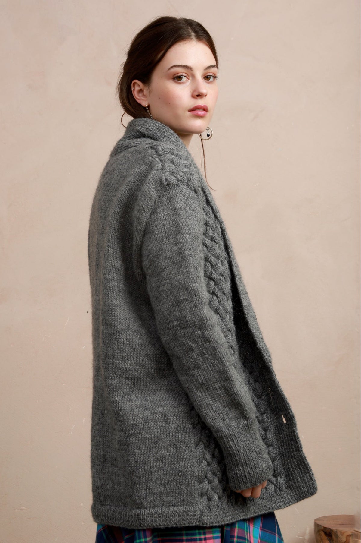 Side profile view of model wearing the longline charcoal grey basket stitch cardigan
