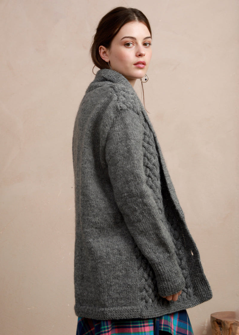 Side profile view of model wearing the longline charcoal grey basket stitch cardigan