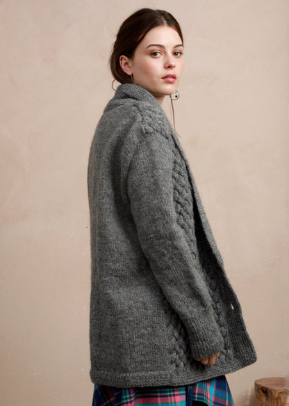 Side profile view of model wearing the longline charcoal grey basket stitch cardigan