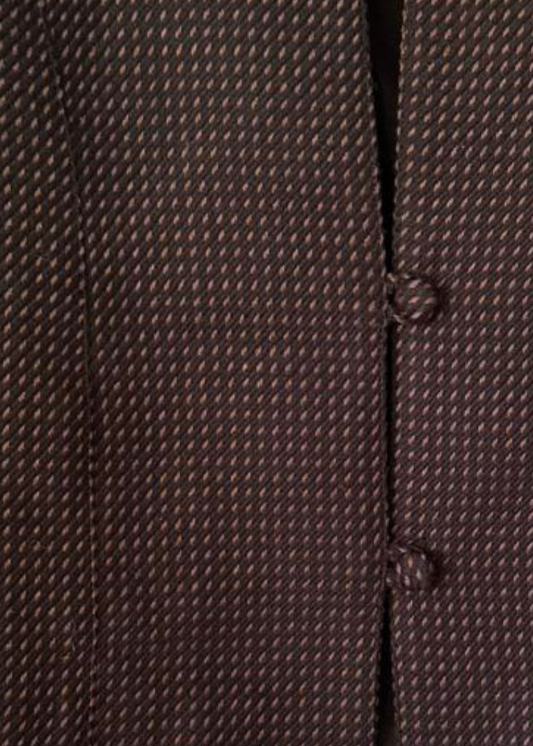 Close-up of a dark brown textured fabric with a fine woven pattern and two matching buttons on a button-front garment.