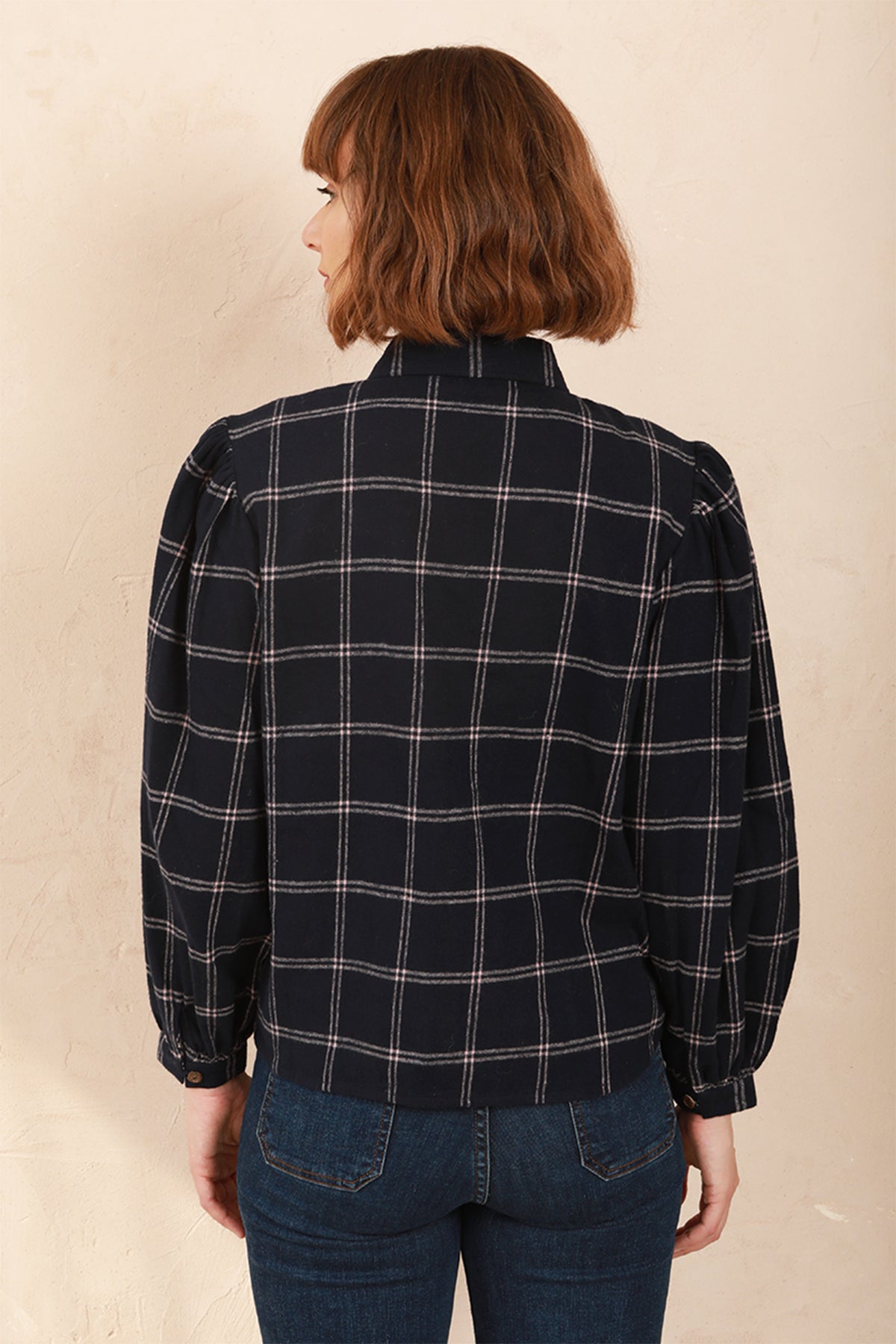 Model wearing the navy and pink Effie Blouse with volume sleeves, Back View