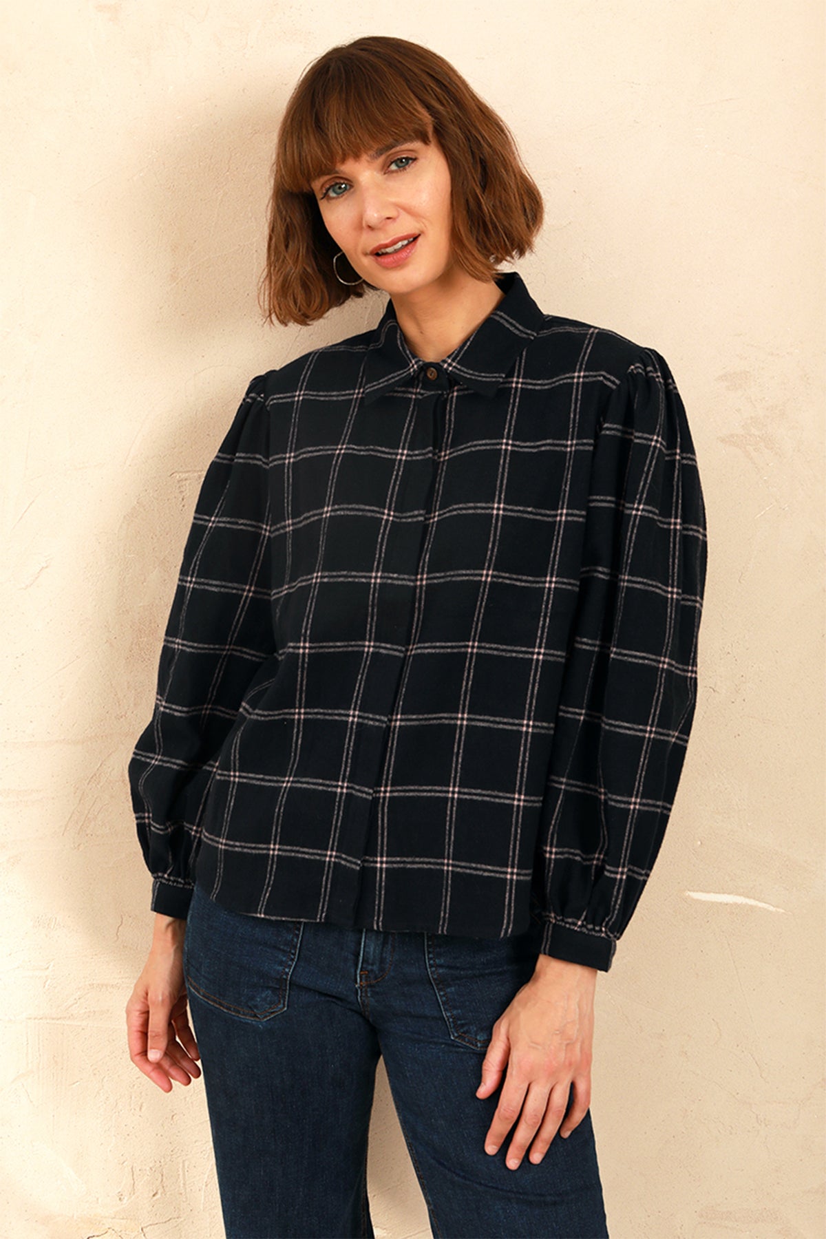Model wearing the navy and pink Effie Blouse with volume sleeves and neat collar