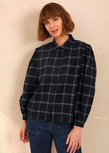Model wearing the navy and pink Effie Blouse with volume sleeves and neat collar