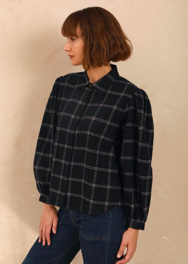 Model wearing the navy and pink Effie Blouse with volume sleeves, side view