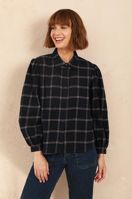 Model wearing the navy and pink Effie Blouse with volume sleeves and neat collar