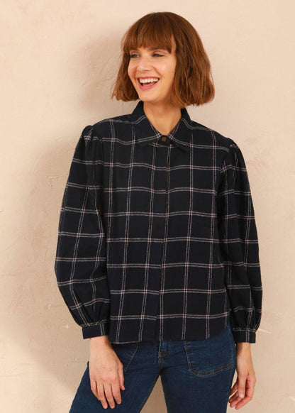 Model wearing the navy and pink Effie Blouse with volume sleeves and neat collar