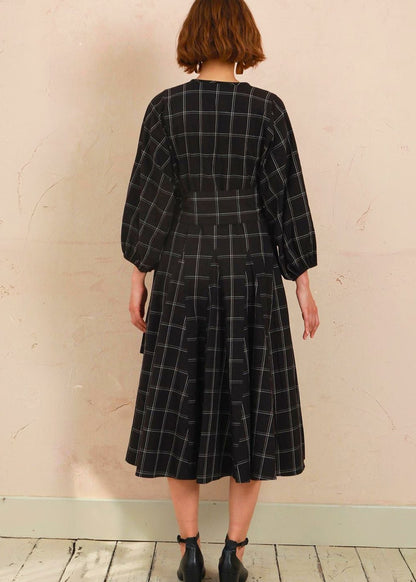 Back view of model wearing the black and white check Penny Dress showing fit and drape