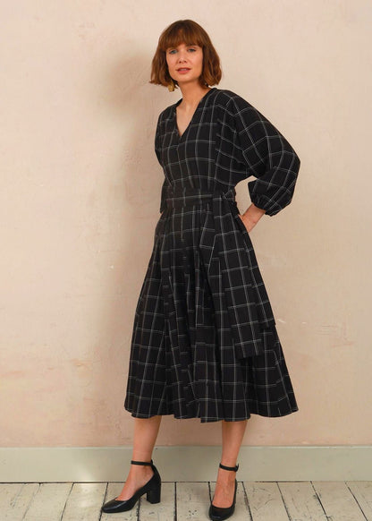 Model wearing the black and white check Penny Dress 