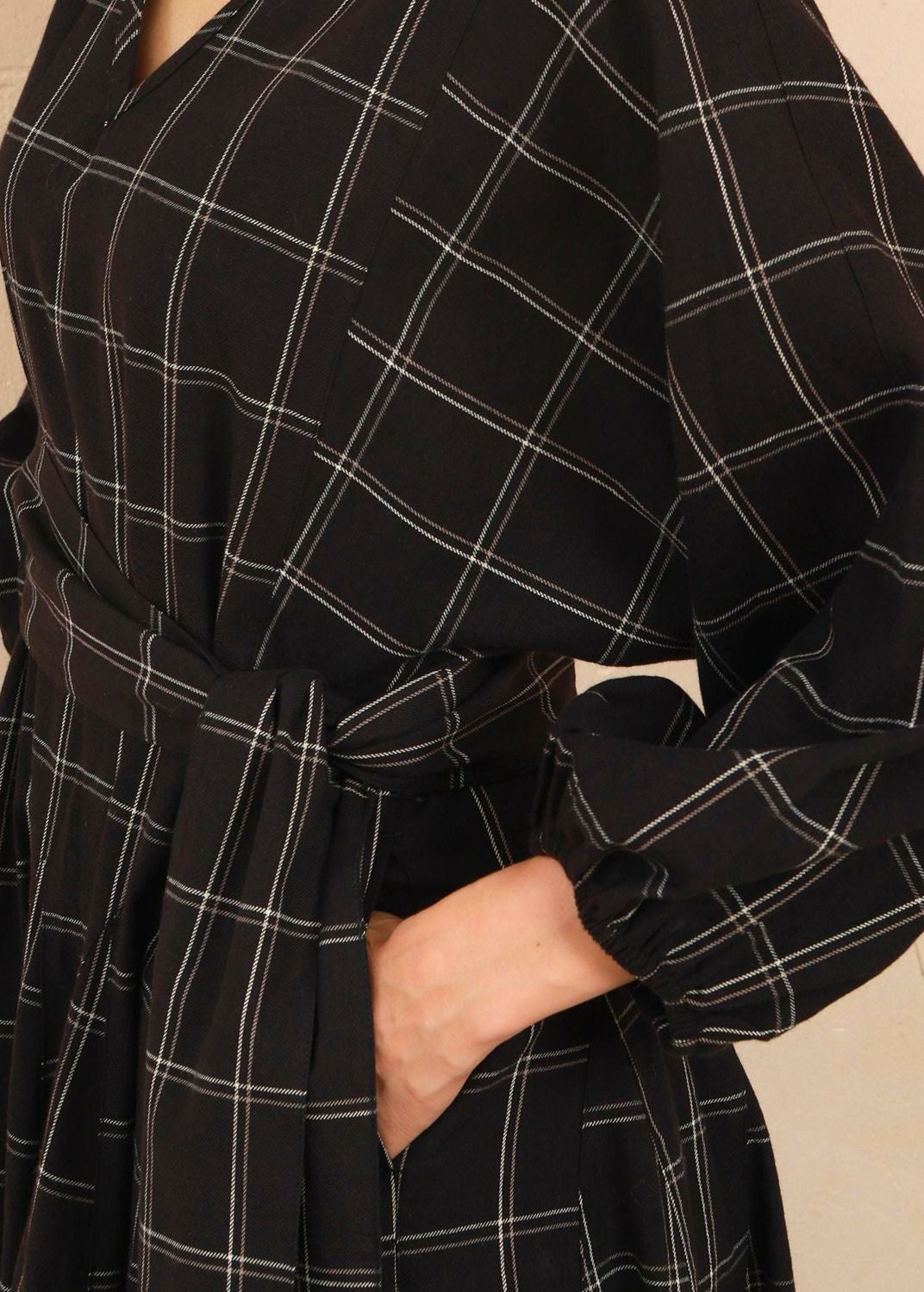 Close-up detail shot showing the woven black and white check pattern and stitching on the Penny Dress