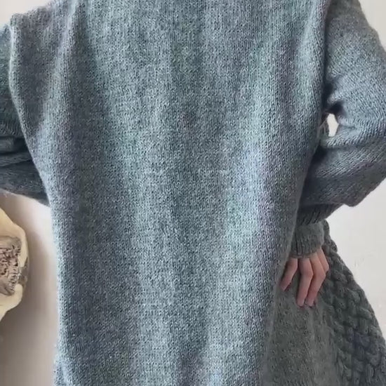Close-up back view showing the texture and hem length of the charcoal grey basket stitch cardigan