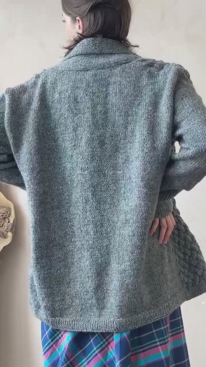 Close-up back view showing the texture and hem length of the charcoal grey basket stitch cardigan