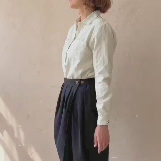 Model walking in the black handwoven Venus Skirt showing fluid drape and movement