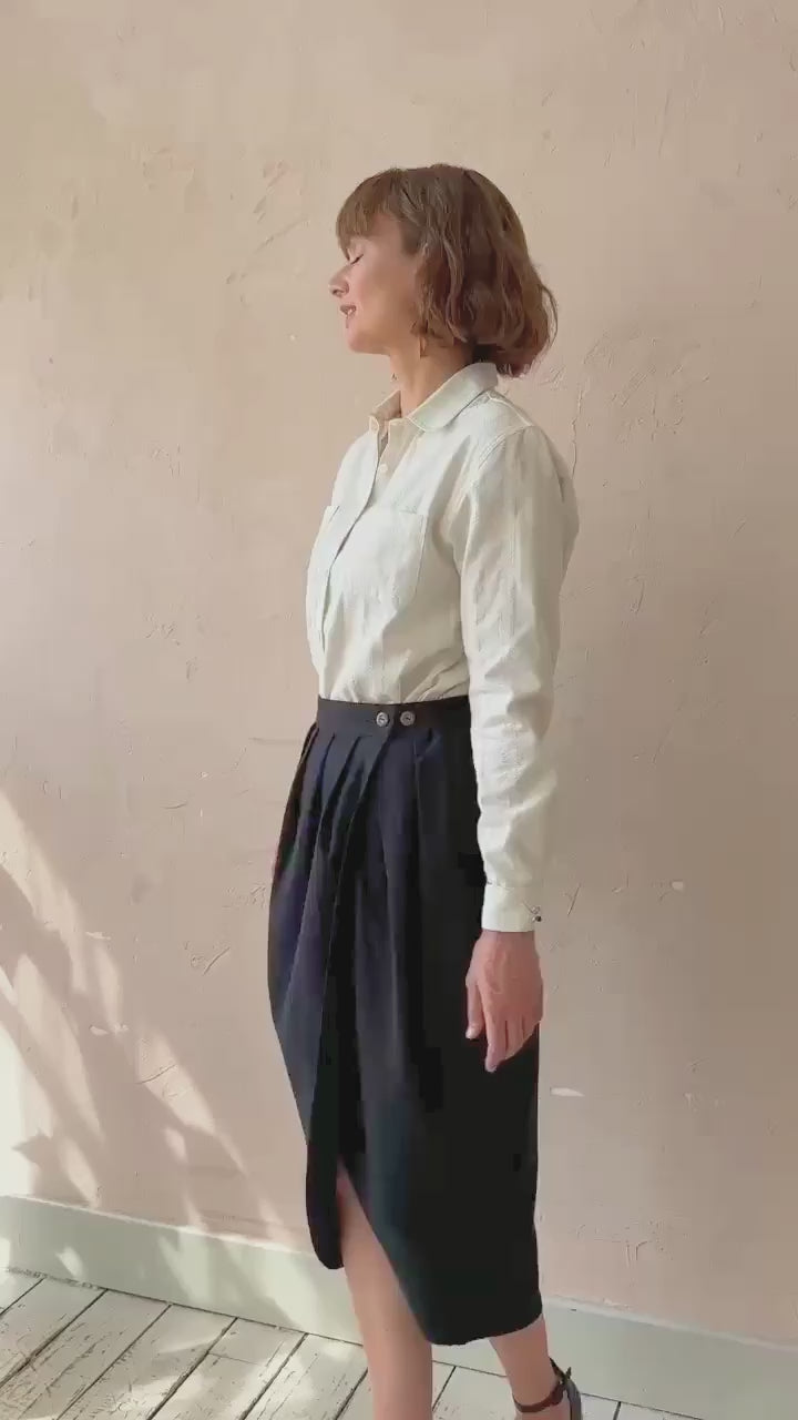Model walking in the black handwoven Venus Skirt showing fluid drape and movement