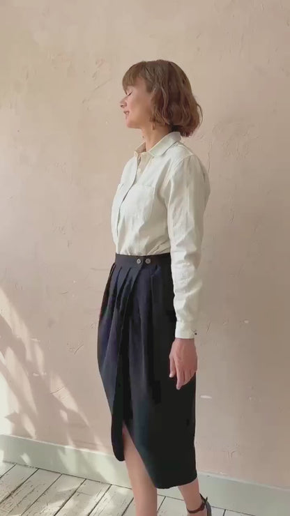 Model walking in the black handwoven Venus Skirt showing fluid drape and movement