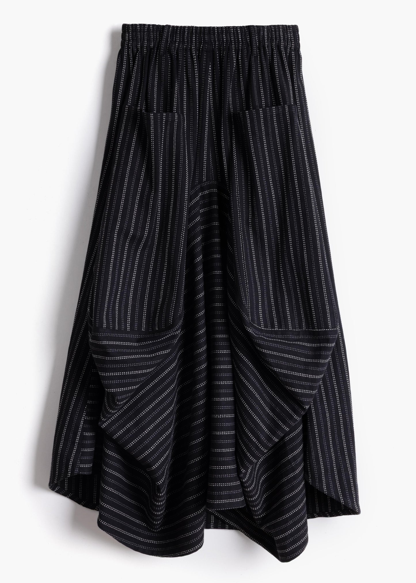 Studio product shot of the black stripe Safia Skirt showing asymmetrical draped hem and pinstripe pattern
