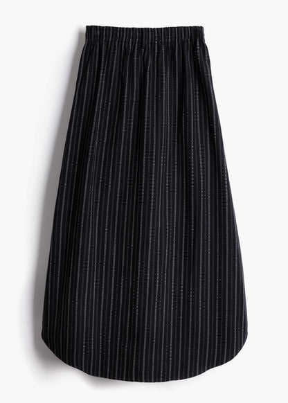 Studio product shot showing the back view and stretch waistband of the black stripe Safia Skirt