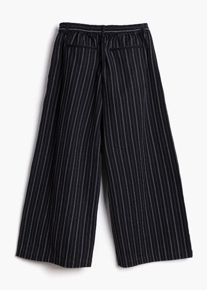 Full-length studio product shot of the black stripe Sarah Trousers showing the wide-leg cut back view