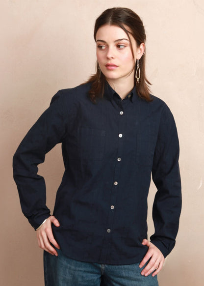 Model wearing the deep navy Sylvia Shirt with rounded collar and hands on hips