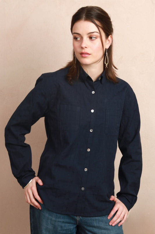Model wearing the deep navy Sylvia Shirt with rounded collar and hands on hips