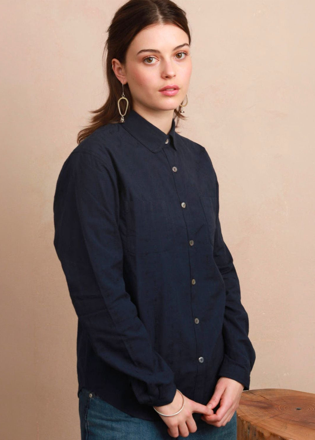 Three-quarter view of model wearing the navy Sylvia Shirt showing relaxed tailoring