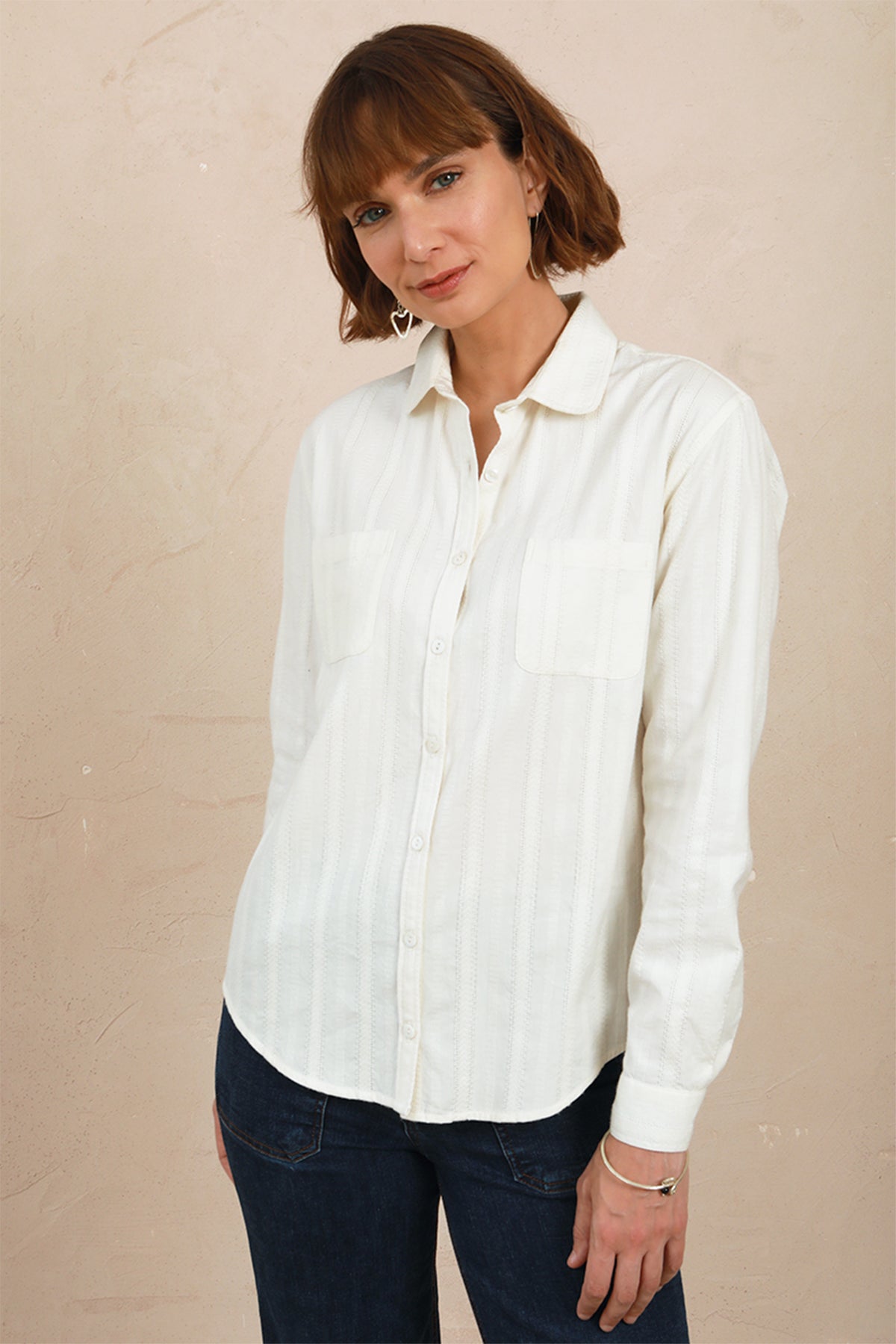 Medium front view of model wearing the white lace Sylvia Shirt worn with dark denim