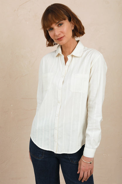 Medium front view of model wearing the white lace Sylvia Shirt worn with dark denim