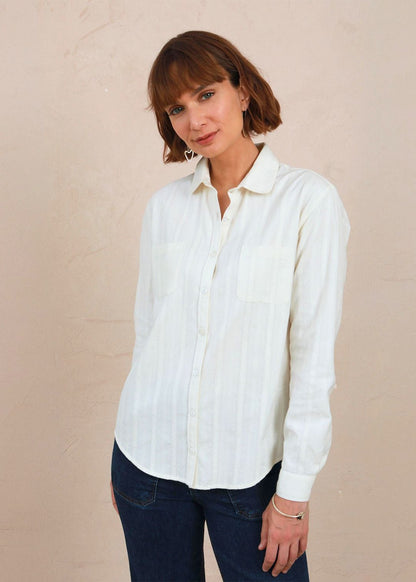 Medium front view of model wearing the white lace Sylvia Shirt worn with dark denim