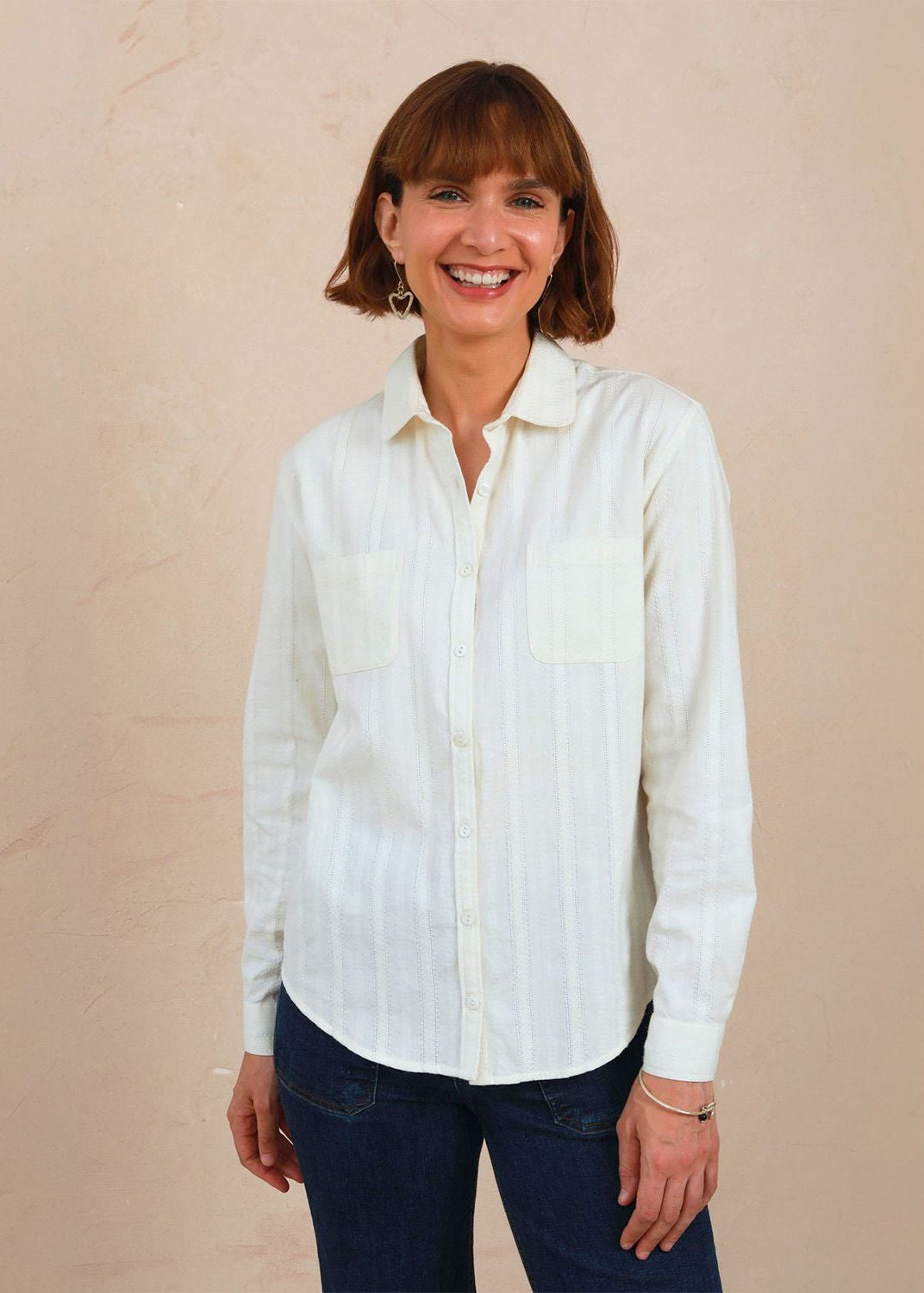 Three-quarter view of model wearing the white lace Sylvia Shirt buttoned up