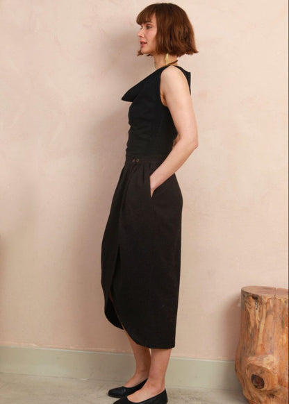 Side view of model wearing the black and brown jacquard Venus Skirt showing fit and midi length
