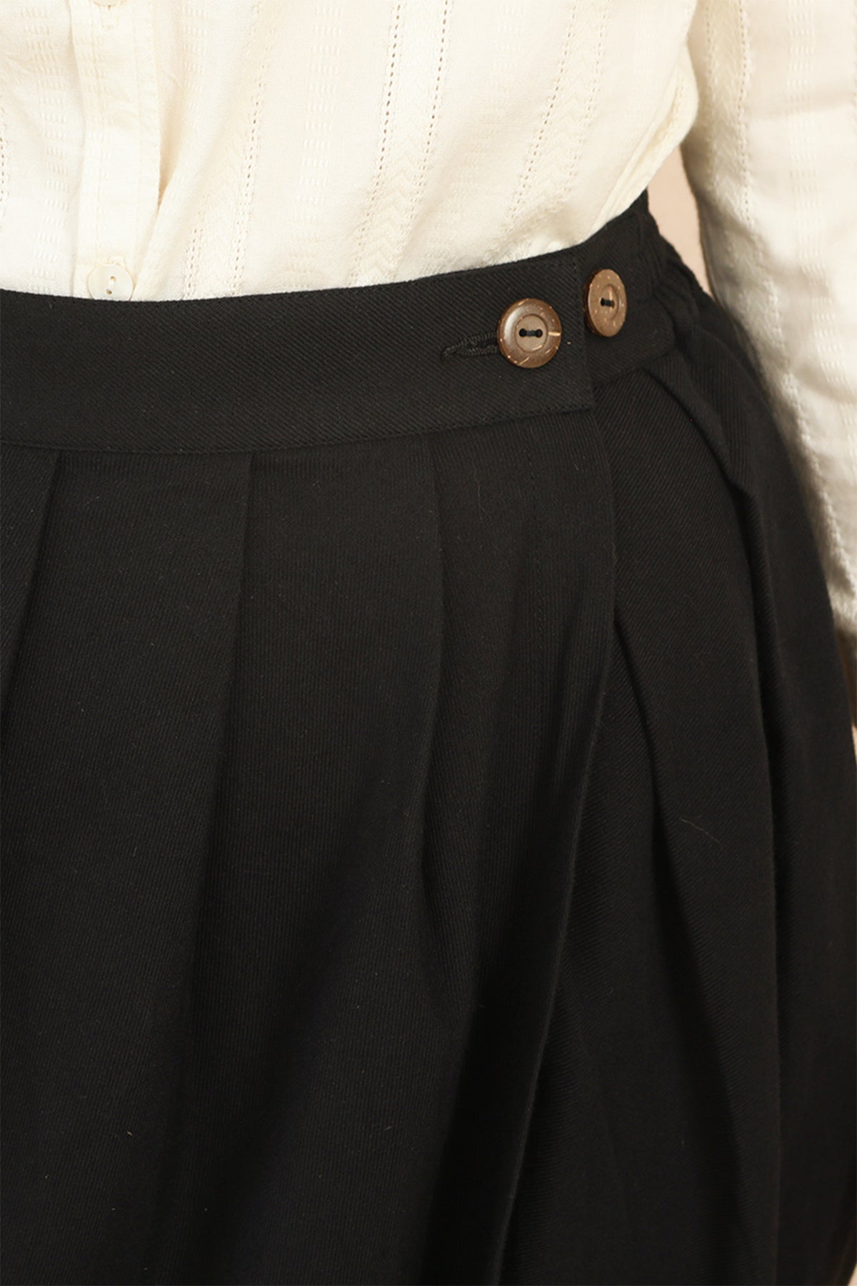 Close-up shot of the waistband on the black Venus Skirt showing natural coconut shell buttons