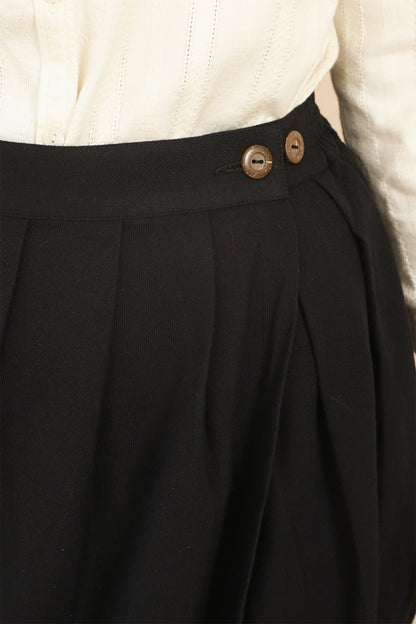 Close-up shot of the waistband on the black Venus Skirt showing natural coconut shell buttons