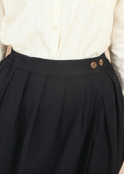 Close-up shot of the waistband on the black Venus Skirt showing natural coconut shell buttons