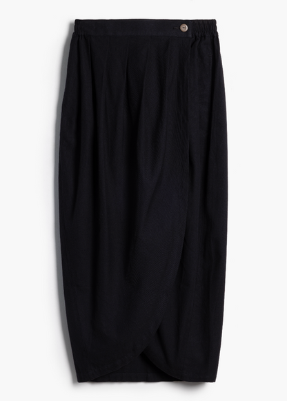 Studio product shot of the black handwoven Venus Skirt with asymmetric front seam