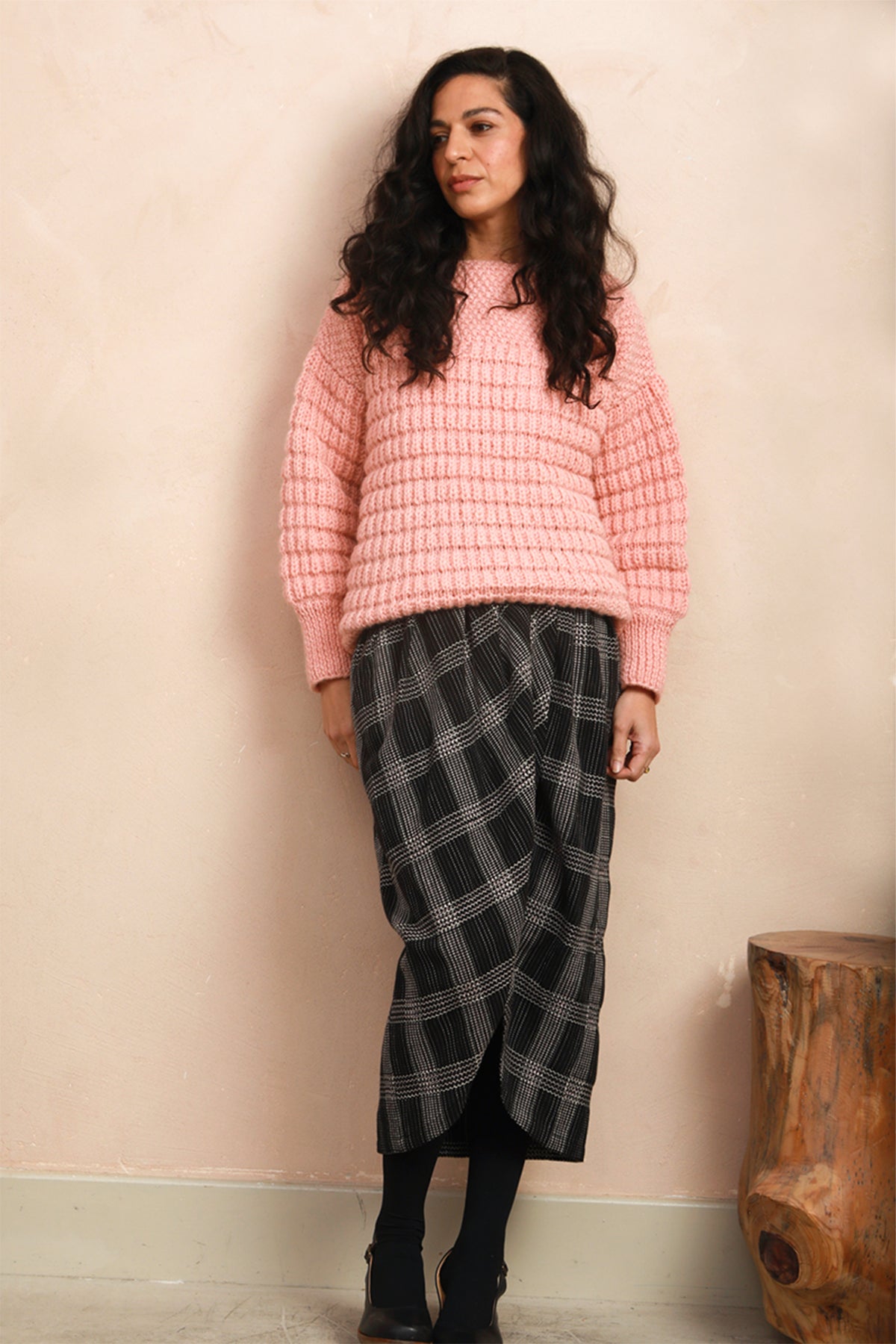 Model wearing the black Nachnakhati stitch Venus Skirt styled with a pink hand-knit sweater