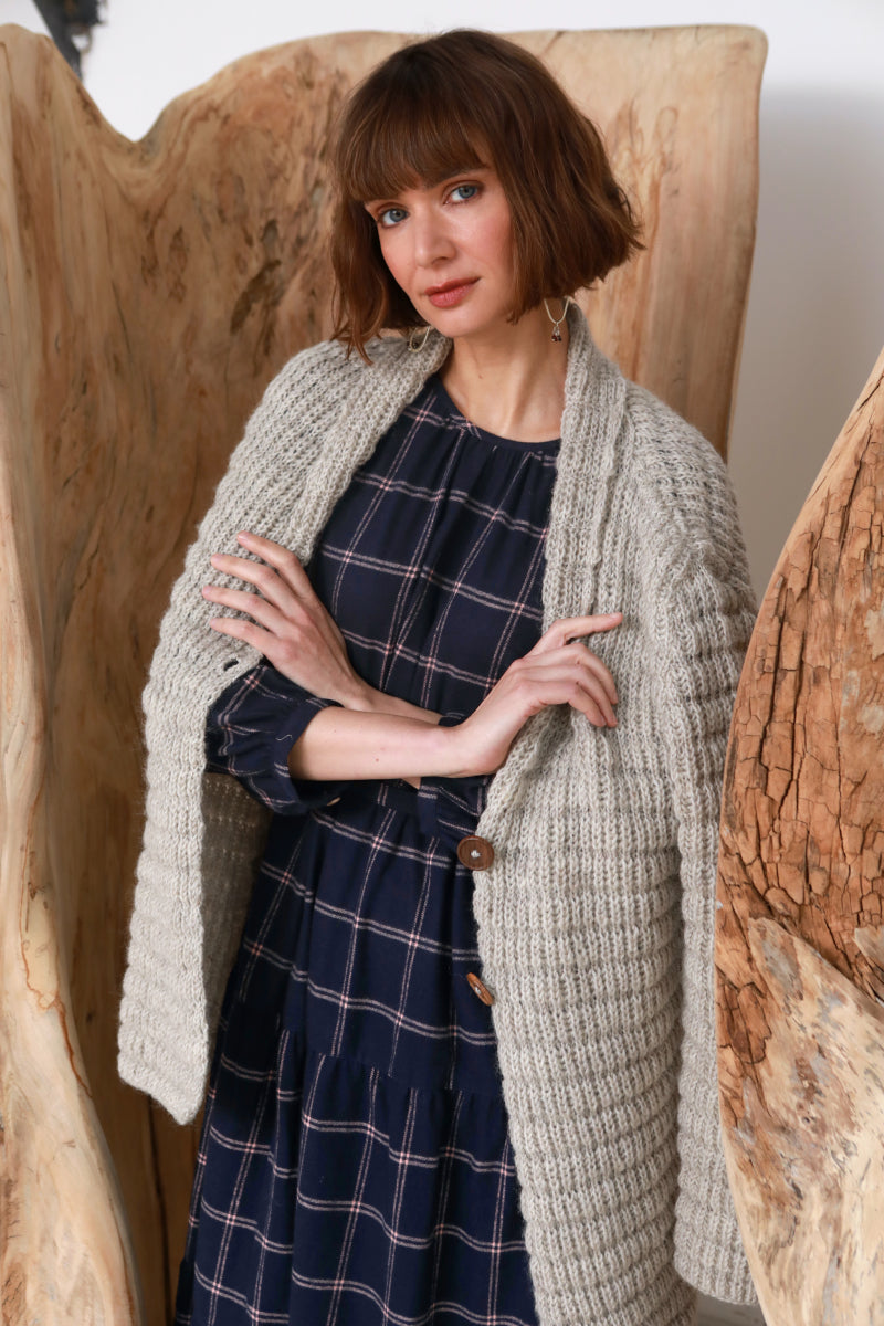 Model wearing the Waffle Longline Cardigan layered over the Roseby Dress in check